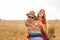 Happy Couple Having Fun Outdoors on wheat field. Laughing Joyful Family together. Freedom Concept. Piggyback