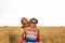 Happy Couple Having Fun Outdoors on wheat field. Laughing Joyful Family together. Freedom Concept. Piggyback