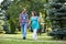 Happy couple, having joined hands walk in park