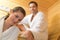 Happy couple having steam bath in sauna