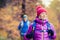 Happy couple hikers walking in autumn forest