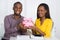 Happy Couple Holding Piggybank