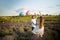 Happy couple holding surprise balloon during gender reveal party in lavender field.