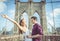 Happy couple hugging each other on the famous brooklyn bridge