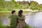 Happy couple hugging on lake or river bank
