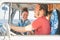 Happy couple inside a vintage minivan making a roadtrip - Travelers driving next to the coast with a van camper