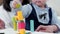 Happy couple and kid playing colorful blocks toy in livingroom. Family lifestyle and togetherness at home on holiday