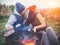 Happy couple kissing and roasting marshmallows on campfire on nature. Cheerful man and woman rest at the fire. Date on the nature