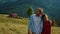 Happy couple look mountains landscape view. Relaxed lovers spend time on walk.