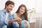 Happy couple looking at globe, choosing country to visit