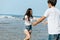 Happy couple in love on the beach. Woman running into men`s embrace on the beach