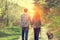 Happy couple in love with dog walking on rural road