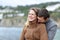 Happy couple in love flirting on the beach in winter