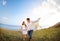 Happy couple in love with flying a kite on the beach