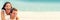 Happy couple in love having fun laughing on summer beach travel vacation panoramic header background. Young lovers on