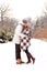 Happy couple in love kissing in park in winter