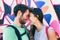 Happy couple in love taking a selfie doing funny kissing pose at famous tourist attraction Berlin wall, Germany, Europe travel