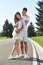 Happy couple in love waiting for child pregnancy hug walk in the summer park green trees nature husband and wife baby boy young