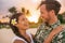 Happy couple lovers in love on romantic sunset beach vacation in Hawaii travel. Asian woman hugging Caucasian man smiling,