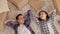 Happy couple lying on the floor in a new apartment