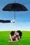 Happy couple lying on grass under umbrella