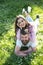 Happy couple lying on green grass meadow. Bearded man and brunette girl on picnic, spring time concept. Smiling man