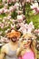 Happy couple making selfie on smartphone at blossoming magnolia trees