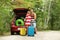 Happy couple near car trunk with suitcases