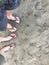 Happy couple with pale skin in flip flops at San Simeon point beach