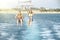 Happy couple Parasailing on Beach in summer. two people under parachute hanging in air above sea surface