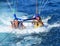 Happy couple parasailing on beach in summer. two people under parachute lowered into sea for fun