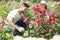 Happy couple planting flowers at the garden