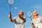 Happy couple playing badminton