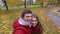 Happy couple recording video in autumn park