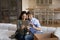 Happy couple relax on moving day using tablet