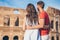 Happy couple in Rome over Coliseum background. Italian european vacation