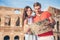 Happy couple in Rome over Coliseum background. Italian european vacation