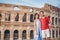 Happy couple in Rome over Coliseum background. Italian european vacation