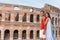 Happy couple in Rome over Coliseum background. Italian european vacation