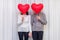 Happy couple seniors celebrate Valentines Day. Faceless couple with no face behind heart balloon. Romantic relationships