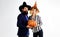 Happy couple sexy woman witch and handsome bearded man with Halloween pumpkin. Two friends in Haloween costumes with