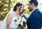 Happy couple sharing moment on their wedding day. Bride and groom being affectionate on their special day. Woman holding