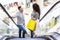 Happy couple with shopping bags rising on escalator