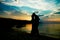 Happy couple silhouette by the Greek sea on the shore background