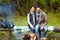 Happy couple sitting on bench near camp fire