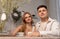 Happy couple sitting at kitchen portrait. Beautiful woman and handsome man drinking tea or coffee. Tender relations