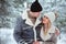 Happy couple spending good day outdoor in winter forest