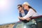 Happy couple standing in cabriolet and admiring nature