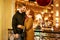 Happy couple stands in an embrace on the street in the evening in the festive lights