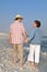 Happy Couple Strolling on Beach at Sunset